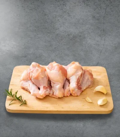 Baby drumsticks on a wooden cutting board