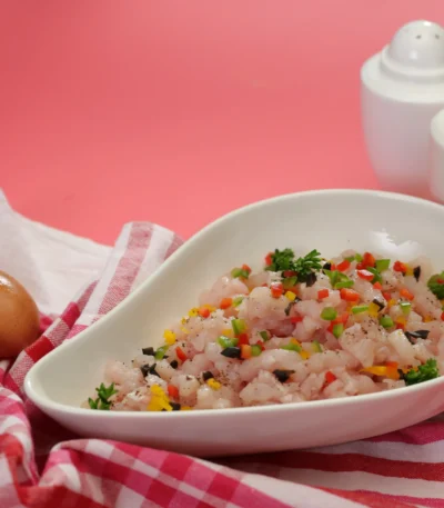 Anthoney’s minced chicken breast meat on a plate with two eggs on side