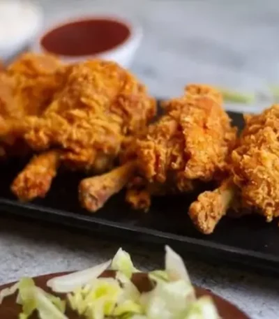 Crispy Chicken Lollipops served with a sauce